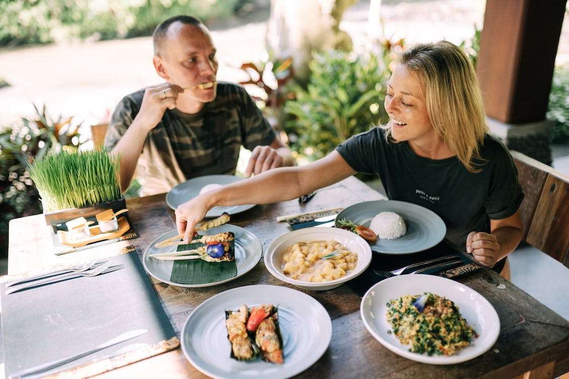 Free Man and Woman Eating Dinner on a Terrace Stock Photo